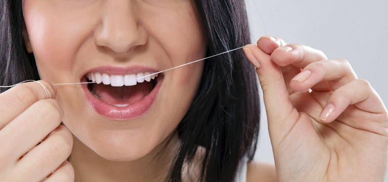 Woman Flossing